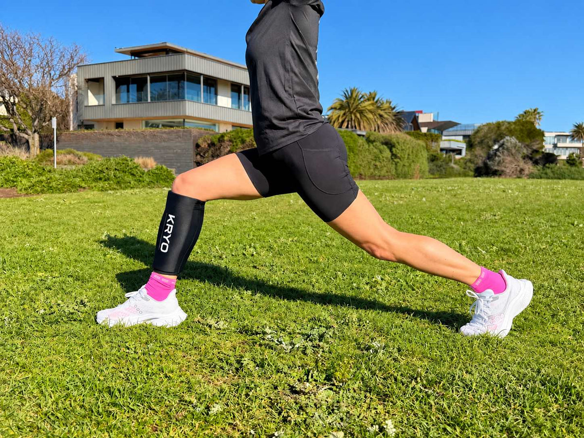 Runner wearing a KRYO hot and cold gel sleeve for calf recovery after training