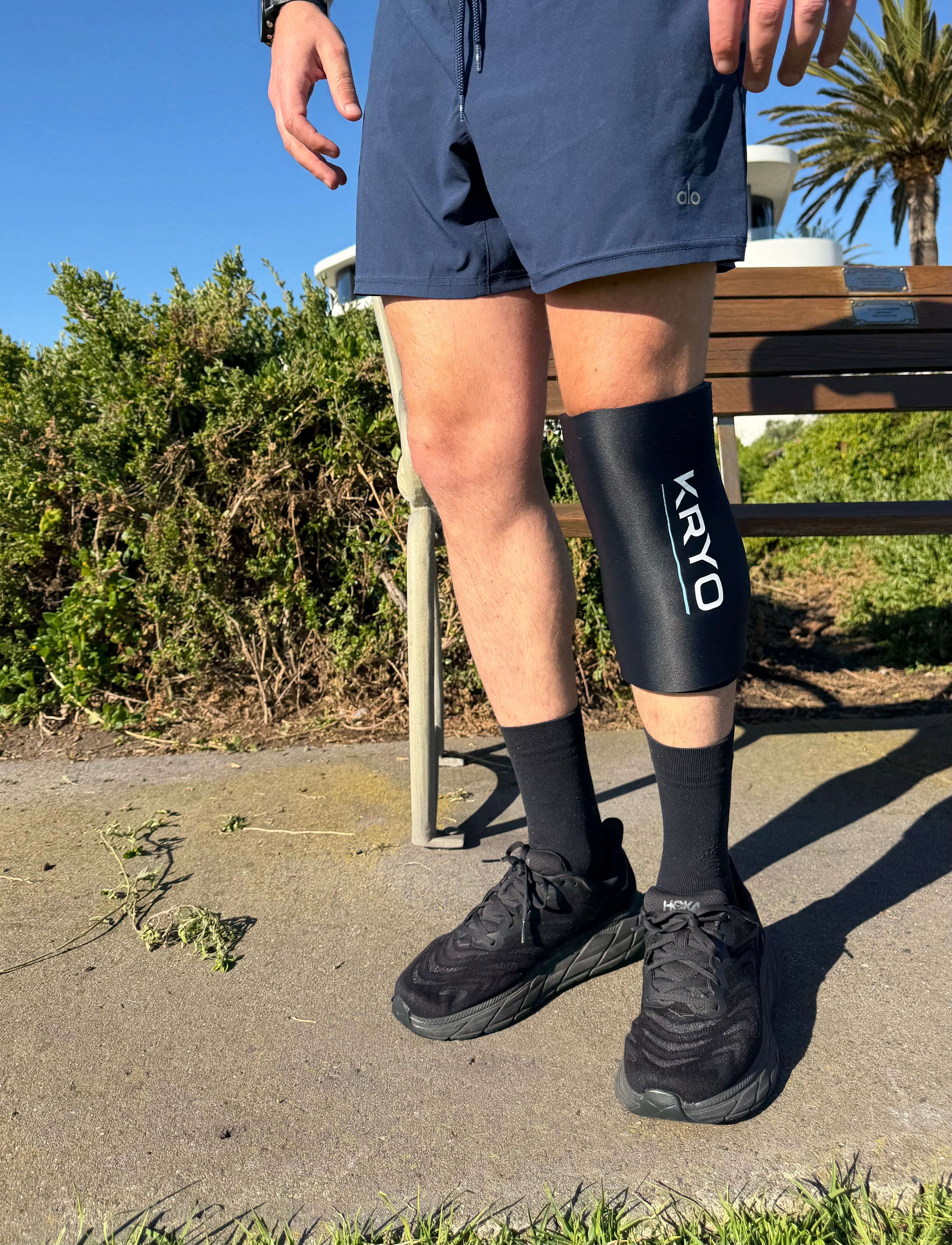 Runner wearing the KRYO CORE knee ice compression sleeve after a beach run