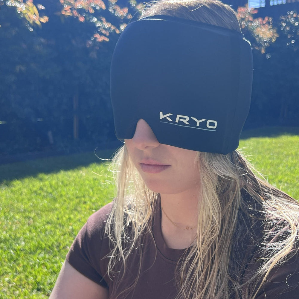 Woman wearing the KRYO Head Ice Cap outdoors, featuring soft, flexible gel coverage for the head, forehead and eyes.