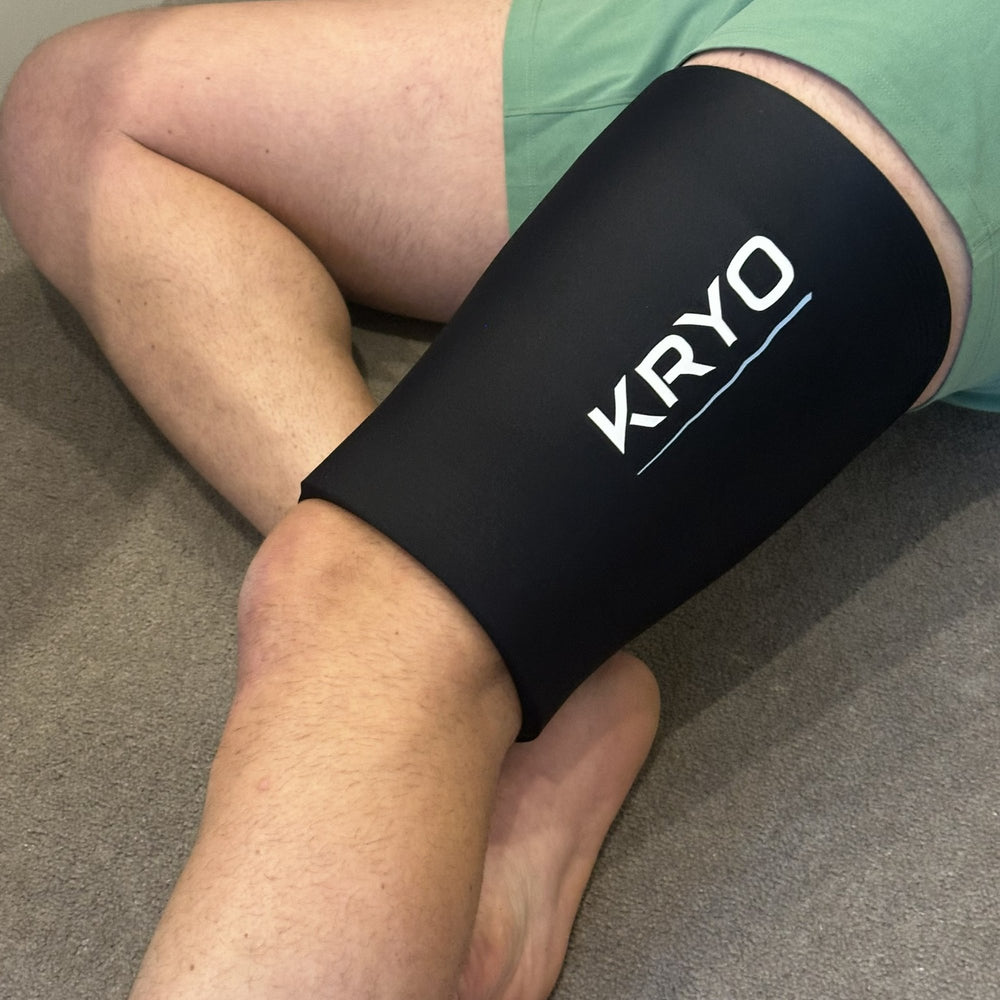 Runner wearing KRYO MAX ice compression sleeve on upper thigh for quad and hamstring recovery post running session.