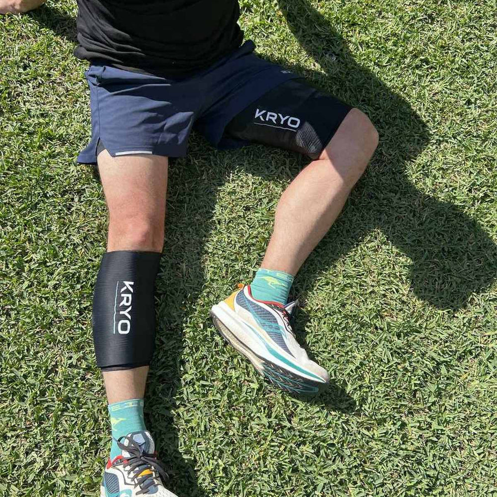 Runner recovering after a workout with KRYO MAX thigh and CORE calf ice compression sleeves
