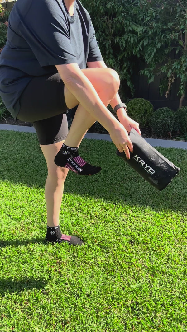 KRYO MAX ice compression sleeve worn by a woman on the thigh for post-training quad and upper leg recovery