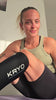Female runner wearing the KRYO CORE hot and cold compression sleeve for post-run recovery and targeted compression therapy. 