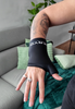 Female athlete demonstrating the KRYO Wrist Ice Compression Sleeve for targeted cold compression and post-workout recovery of the wrists and hands.